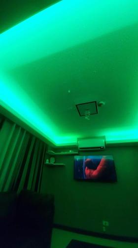 a green light on the ceiling of a room at Twins staycation by wench in Cambridge condo in Cainta