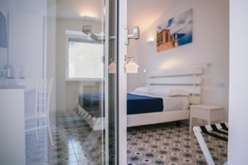 a bedroom with a bed and a sliding glass door at A Gradillo holiday rooms in Ravello