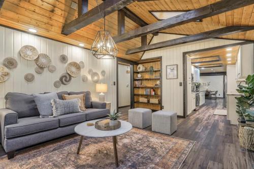 a living room with a couch and a table at Pinewood Meadow & Scenic Hot Tub & BBQ & Outdoors in Colorado Springs