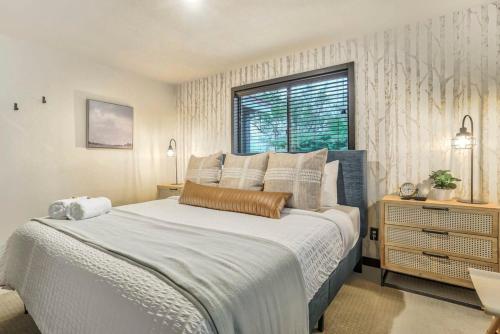 a bedroom with a large bed and a window at Pinewood Meadow & Scenic Hot Tub & BBQ & Outdoors in Colorado Springs