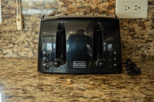 a toaster oven sitting on a counter with a person in it at 113 Big Town House For Family W Pool in Cabo San Lucas