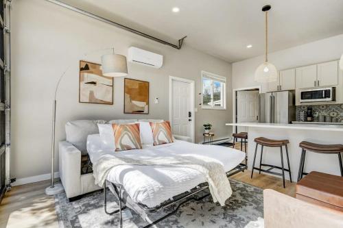 a bedroom with a bed and a kitchen at Pinewood Sanctuary Secluded & Peaceful OCC Oasis in Colorado Springs