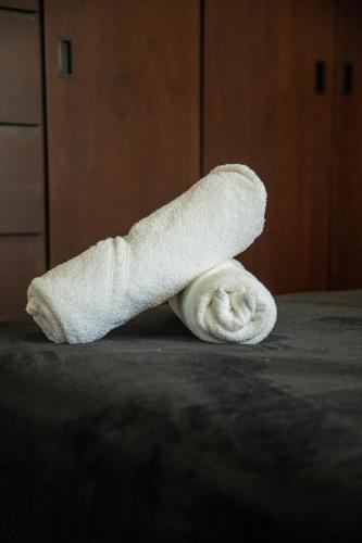 a rolled up white towel sitting on a table at 113 Big Town House For Family W Pool in Cabo San Lucas