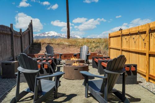 a group of chairs sitting around a fire pit at Rockies Rainbow Road Hot Tub Pikes Peak Views Pac Man in Colorado Springs