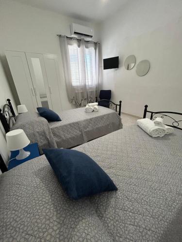 a bedroom with two beds and a television in it at Marisol in Marsala