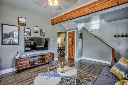 a living room with a couch and a tv at The Vibrant Victorian Hot Tub & Fire Pit in OCC in Colorado Springs
