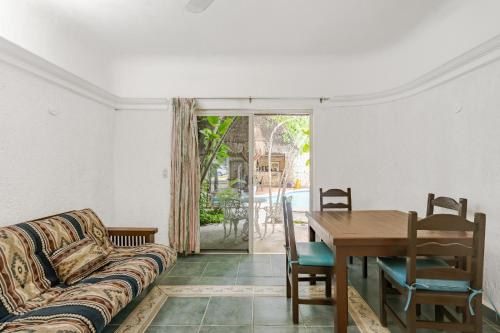 a living room with a couch and a table at MAYAN ART Hotel Boutique - 10Th Ave in Playa del Carmen