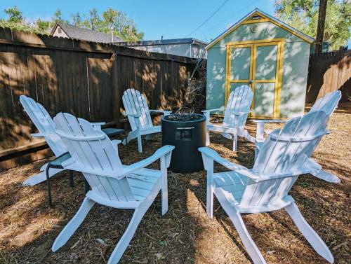 a group of chairs and a trash can in a yard at The Vibrant Victorian Hot Tub & Fire Pit in OCC in Colorado Springs