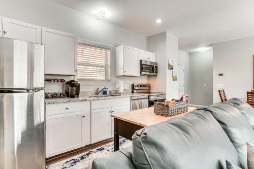 a kitchen with white cabinets and a gray couch at Charming Helen Vacation Rental 2 Mi to Village! in Helen