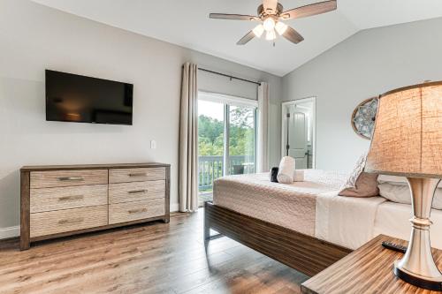 a bedroom with a bed and a flat screen tv at Charming Helen Vacation Rental 2 Mi to Village! in Helen