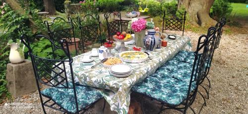 a table with a table cloth with food on it at Casale del Cantico in Brenta