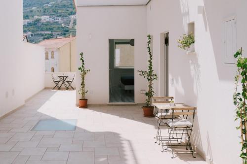 a courtyard with a table and chairs on a building at A Gradillo holiday rooms in Ravello