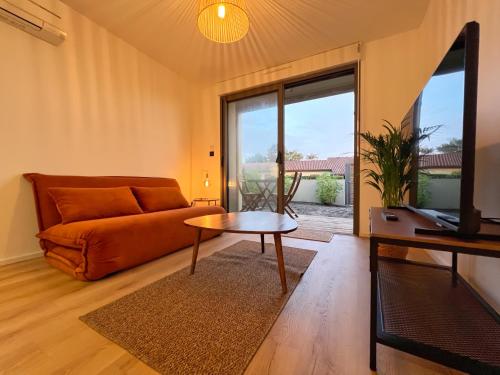 a living room with a couch and a table at Premium surf lodge in Capbreton