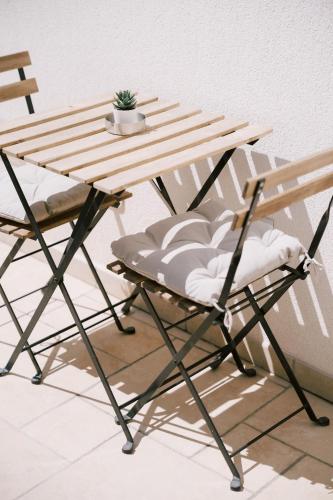 a wooden table and a chair next to a table at A Gradillo holiday rooms in Ravello