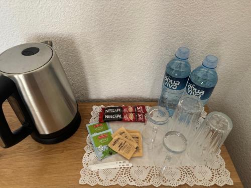 a table with two bottles of water and some snacks at Vila Aspen - Mountain View Apartments in Delčevo