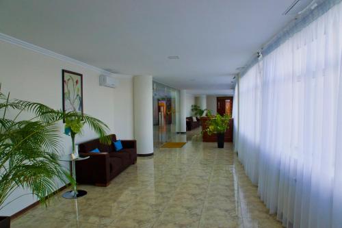 a hallway with a living room with a couch and curtains at Hotel Merkuriy in Lviv