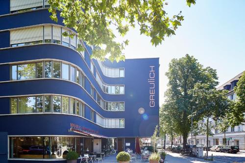 a blue building with a sign on the side of it at Greulich Design & Boutique Hotel in Zürich