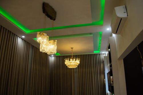 a room with two chandeliers and green lights at Gracimor Hyndland Estate in Lusaka