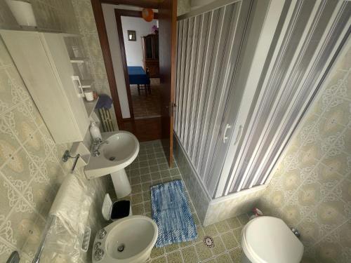 a bathroom with a shower and two toilets and a sink at VistaMare in San Foca