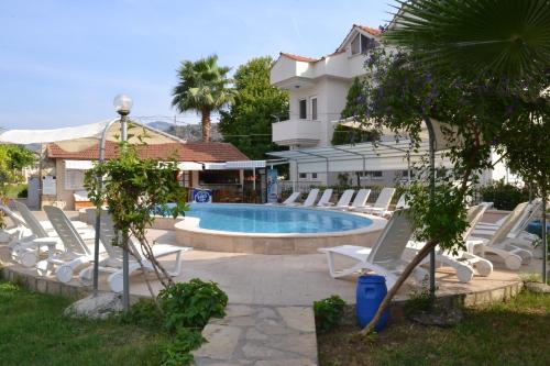 a group of lounge chairs and a swimming pool at Villa Ali Ozalp in Dalyan