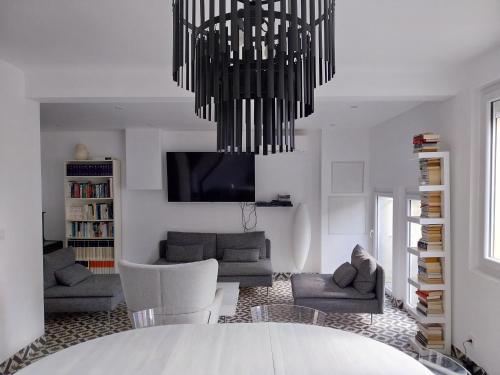 un salon avec un lustre suspendu au plafond dans l'établissement Vacances à la mer, à Banyuls-sur-Mer