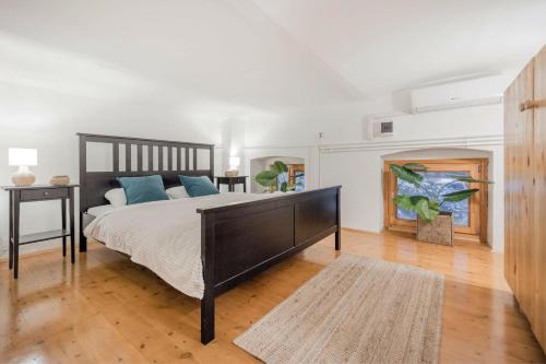 a bedroom with a large bed with blue pillows at Wellness Wonderland Garden, Sauna, Jacuzzi in CBD in Budapest