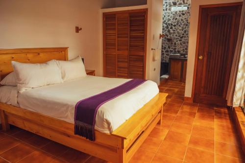 a bedroom with a large bed in a room at El Dragon Hotel in San Marcos La Laguna