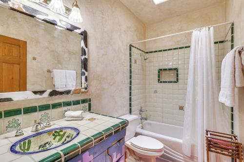a bathroom with a sink and a toilet and a tub at Chic Tucson Casita with Deck and Panoramic Views! in Tucson