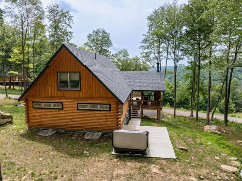 a cabin in the woods with a tv in front of it at Moon and Stars in McHenry