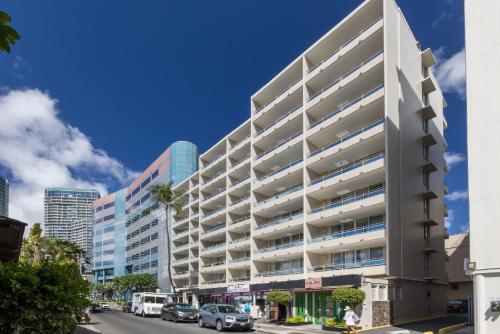 a large white building on a city street at Regency on Beachwalk Waikiki by OUTRIGGER in Honolulu