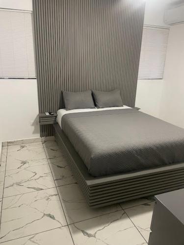 a bed sitting in a room with at LEVEL suites premium in Sosúa