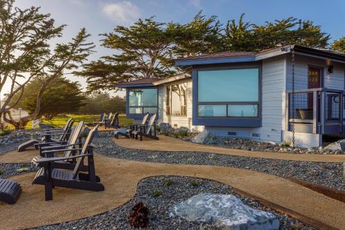 a house with rocking chairs in front of it at Windrush Inn - Cambria in Cambria