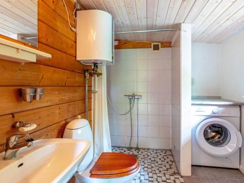 a bathroom with a toilet and a washing machine at 6 person holiday home in Roslev-By Traum in Roslev