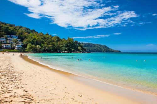 a beach with a group of people in the water at Saiyuan Residence Phuket in Rawai Beach