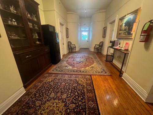 a hallway with a rug on a hard wood floor at Historic Michabelle Inn in Hammond