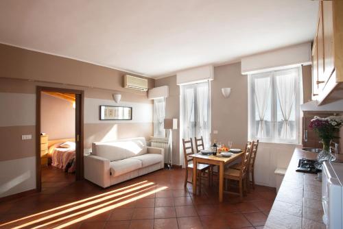 a living room with a white couch and a table at Milan Skyline Apartment in città studi a 1 minuto dal metrò con terrazzo wi-fi e netflix in Milan