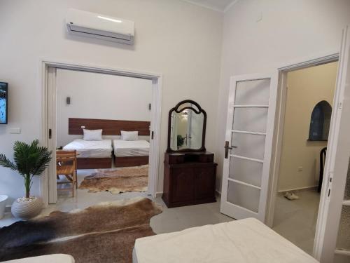 a bedroom with a bed and a mirror at family suites cairo downtown in Cairo