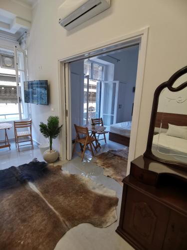 a living room with a large mirror and a room with a table at family suites cairo downtown in Cairo
