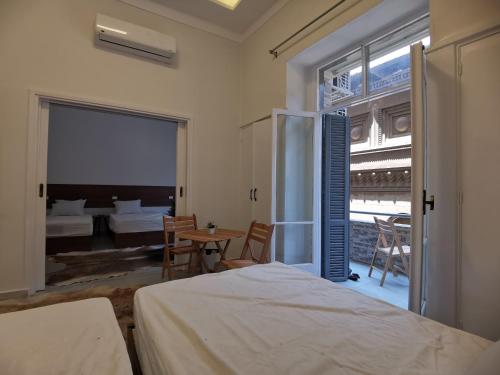 a bedroom with a bed and a view of a room at family suites cairo downtown in Cairo