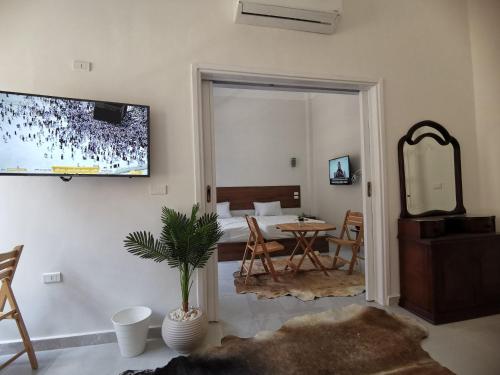 a living room with a television on the wall at family suites cairo downtown in Cairo