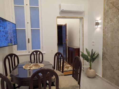 a dining room with a table and chairs at family suites cairo downtown in Cairo