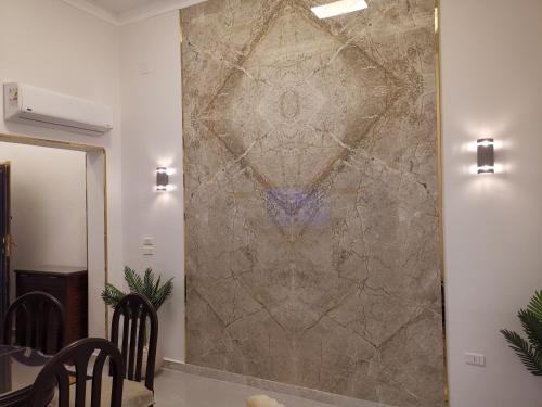 a stone wall in a dining room with a table and chairs at family suites cairo downtown in Cairo