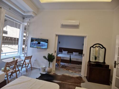 a room with a bed and a table and a mirror at family suites cairo downtown in Cairo