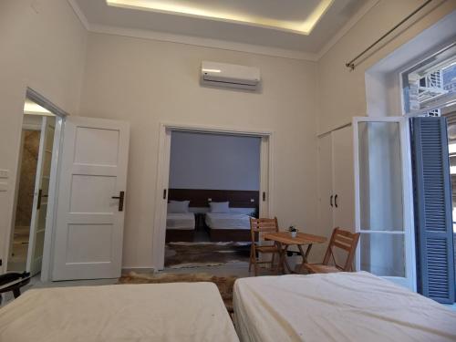 a bedroom with two beds and a table and a room at family suites cairo downtown in Cairo