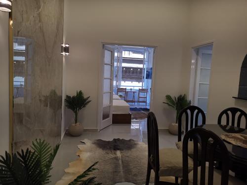 a living room with a table and chairs and a dining room at family suites cairo downtown in Cairo