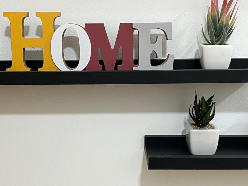 a shelf with plants and a sign that reads hunt at Real Dreams in Sant Jaume d'Enveja