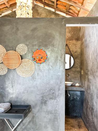 a kitchen with a wall with a painting on it at Refúgio CAJUÍ in Barreirinhas