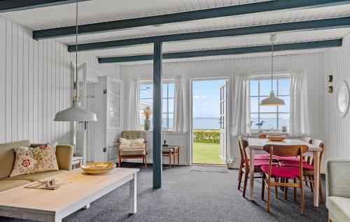 a living room with a table and a dining room at Mosvig in Sønder Bjert