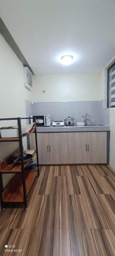 a kitchen with a sink and a counter top at 3 - Cabanatuan City's Best Bed and Breakfast Place in Cabanatuan