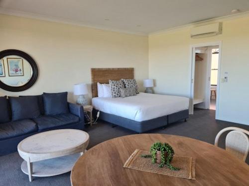 a living room with a bed and a table at Tuileries at De Bortoli Rutherglen in Rutherglen